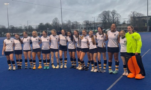 The 16 Girls Hockey Team Lined up on the Pitch